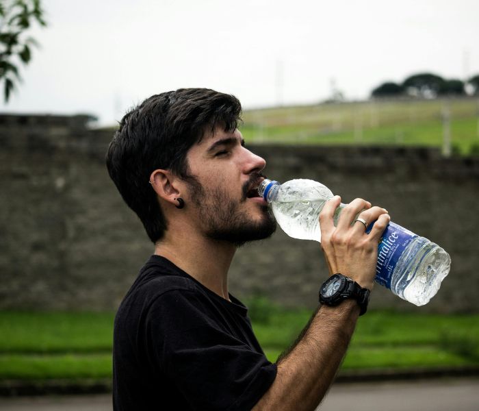 Orang minum air putih setelah berolahraga